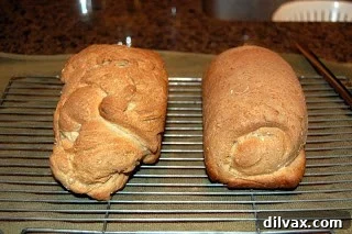 Day 10: My Best Whole-Wheat Oatmeal Bread Yet 5 Two freshly baked whole wheat bread loaves cooling on a wire rack.
