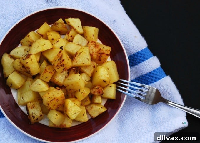 Herby Greek roasted potatoes, perfectly seasoned and cooked to a golden finish, a delightful side dish.