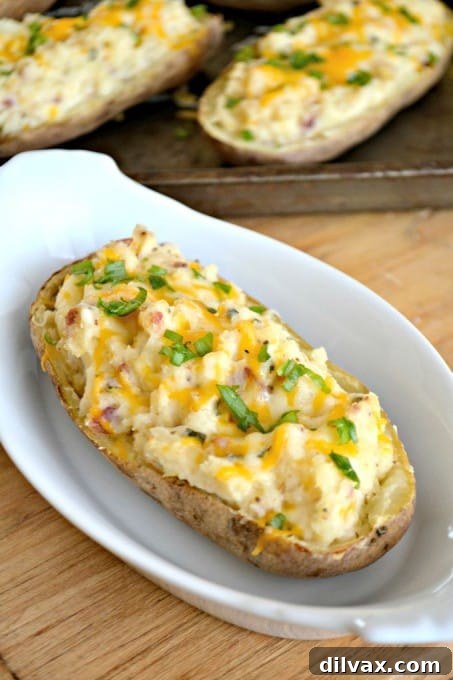 These Twice Baked Potatoes are a culinary delight, featuring a creamy mixture of cream cheese, Greek yogurt, Old Bay Seasoning, and crispy bacon, all re-baked to perfection. An ideal complement to any meat dish.