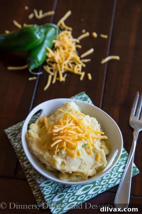 Spicy mashed potatoes with a kick of jalapeño and rich cheddar cheese, a flavorful twist on a classic.