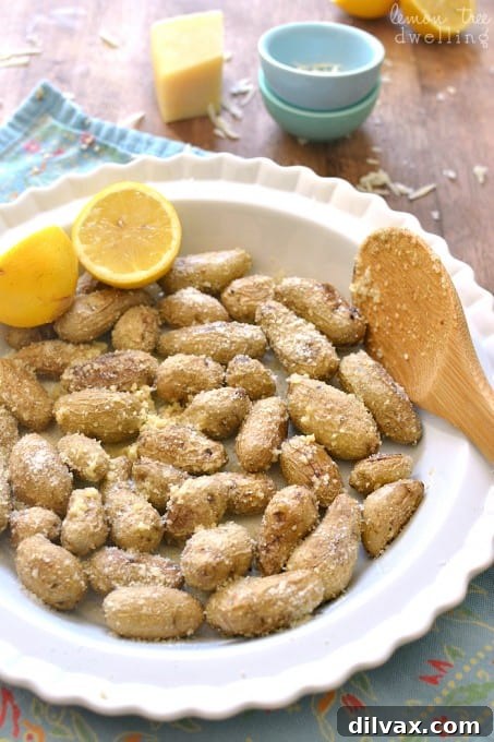 Golden roasted potatoes tossed with zesty lemon and savory Parmesan cheese, a bright and flavorful side.