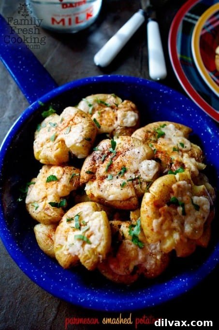 Delicious Parmesan Smashed Potatoes by Marla Meridith, featuring crispy edges and a cheesy flavor.