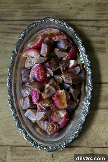 Roasted radishes and potatoes with warm cinnamon and sweet shallots, creating a colorful and flavorful side.