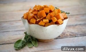 Maple Roasted Sweet Potatoes: Diced sweet potatoes generously tossed with olive oil, fragrant fresh sage and thyme, then drizzled with pure maple syrup and roasted to caramelized perfection. An exquisite side dish for any holiday table.