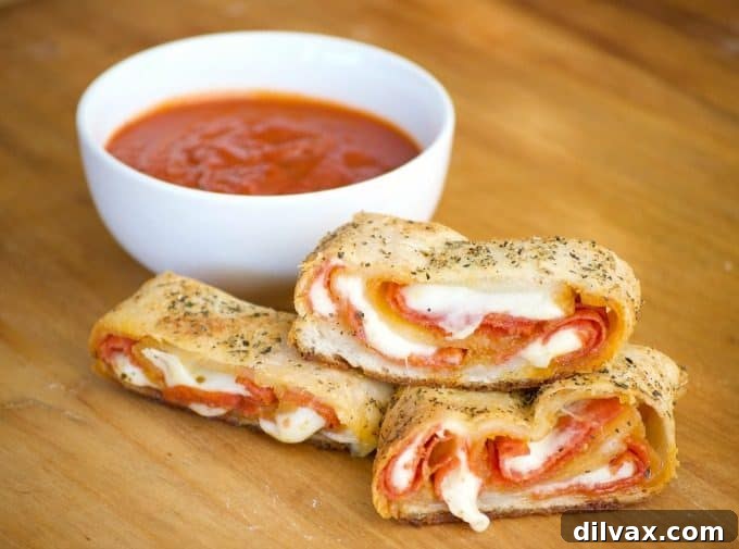 A wider shot of the pepperoni bread, freshly baked and golden, with a few slices already cut, revealing its enticing interior.