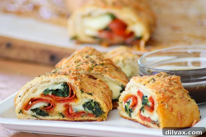 This Spinach Pepperoni Bread is pizza dough filled with spinach, pepperoni, and provolone. It makes a great weeknight dinner, is the perfect finger food for Game Day and is a recipe you'll be asked to bring again to that next potluck!
