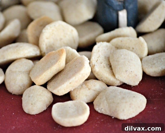 Pebernødder - Danish Christmas Spiced Cookies 6 A handful of Pebernødder cookies artfully arranged on a plate next to holiday decor, inviting a cozy Christmas experience.