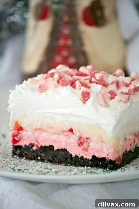 Peppermint Dream Dessert - an Oreo crust, a creamy peppermint layer, white chocolate pudding, crunchy peppermint baking chips and shaved white chocolate make this a fabulous holiday treat!