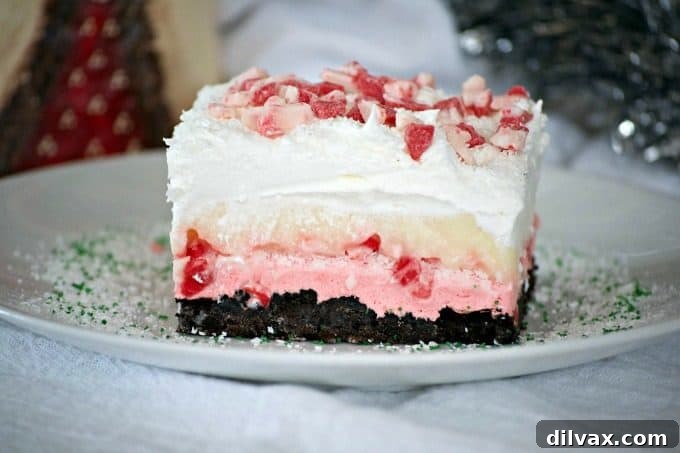 Peppermint Dream Dessert - an Oreo crust, a creamy peppermint layer, white chocolate pudding, crunchy peppermint baking chips and shaved white chocolate make this a fabulous holiday treat!