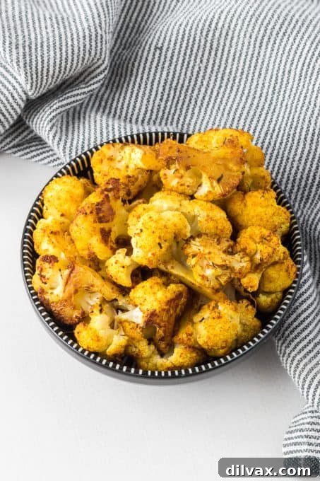 Curry and cajun seasoned cauliflower roasted in the oven.