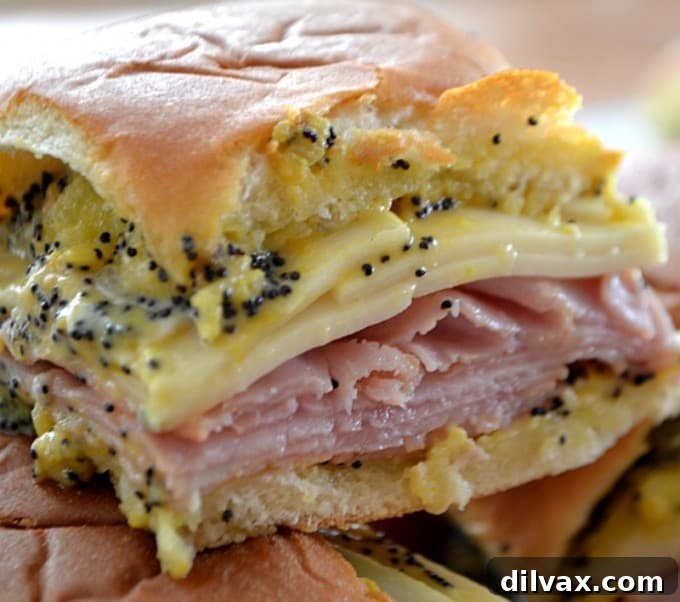Sweet and savory Ham and Cheese Party Sandwiches on Hawaiian rolls with a poppy seed dressing, perfect for any gathering.