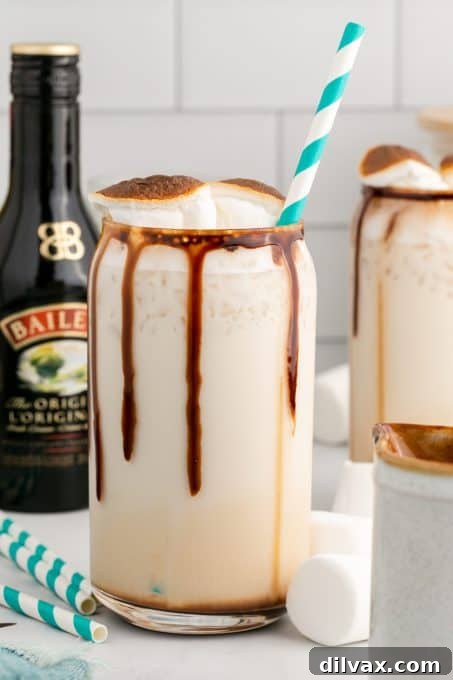 Two glasses of Frozen Marshmallow Mudslide, one in focus, showing the creamy texture and marshmallow garnish.