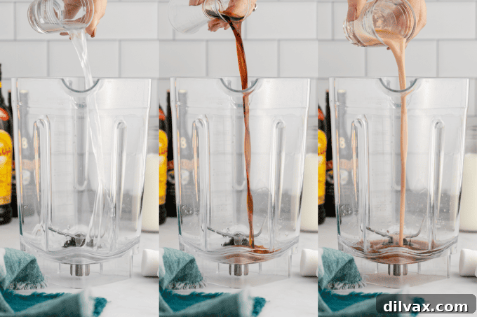 First step of making a Frozen Marshmallow Mudslide: liquor, creamer, and milk being poured into a blender.
