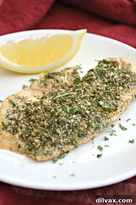 This Steamed Lemon Herb Tilapia is seasoned with fresh lemon, dill, garlic powder and other spices then steamed in the oven in a tin foil packet for a healthy and easy meal.