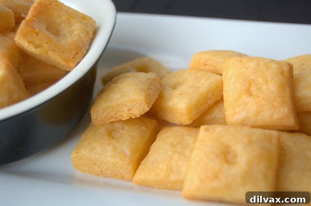 Golden-brown Homemade Cheese Crackers arranged on a plate, ready for snacking.