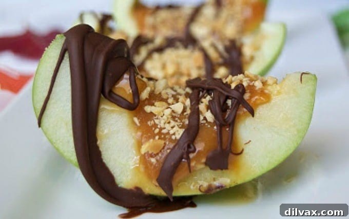 Deconstructed caramel apples served in a bowl, with apple pieces, caramel drizzle, and toppings.