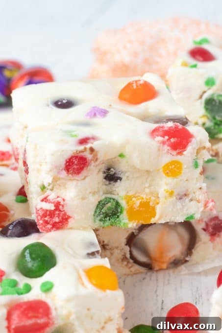 Colorful Easter Fudge 3 Close-up of a square of Easter Fudge, showcasing the vibrant colors of jelly beans and the creamy texture of the white chocolate base.