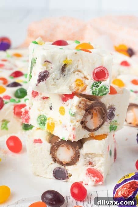 Colorful Easter Fudge 8 A stack of beautifully cut Easter fudge squares, showcasing the thick, creamy texture and colorful mix-ins.