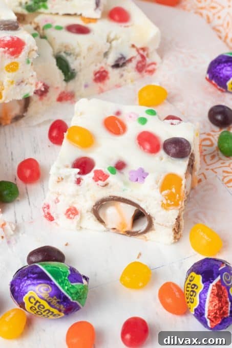 Colorful Easter Fudge 9 Close-up of Easter Fudge highlighting mini Cadbury Creme Eggs and colorful jelly beans embedded within the white chocolate base.