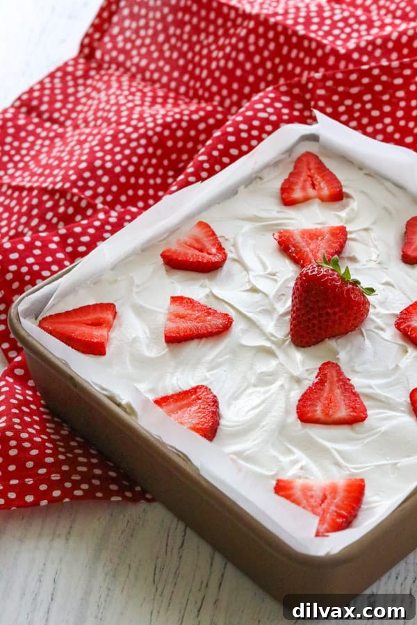 A full pan of glistening Strawberry Cheesecake Dream Bars, ready to be cut and served.
