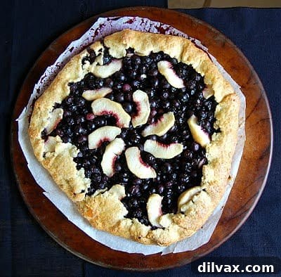 A luscious Blueberry Peach Galette, showcasing the sweet blend of blueberries and peaches in a flaky crust.