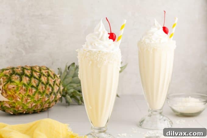 Pina Colada Milkshakes, a creamy blend of pineapple, coconut, and vanilla ice cream, perfect for summer.