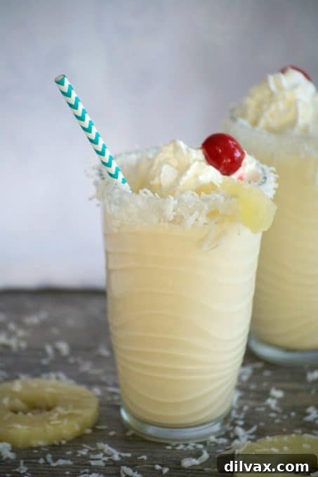 Two glasses of Pina Colada Milkshakes, a perfect tropical refreshment.