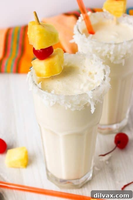 Delicious Pina Colada Milkshakes, blending rum, coconut, and pineapple flavors.
