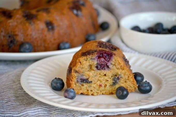 A tantalizing view of the Eggless Blueberry Coriander Bundt Cake on a wire rack, cooling gracefully, hinting at its soft texture and rich aroma.