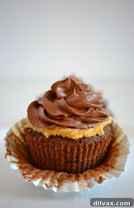 Decadent Peanut Butter Chocolate Cupcakes 4 Close-up of a Double Chocolate Peanut Butter Filled Cupcake showing the rich chocolate exterior and creamy peanut butter filling.