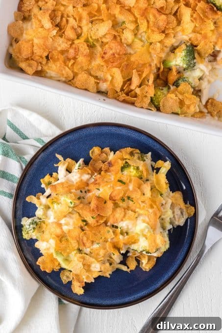 Creamy Chicken and Broccoli Bake 7 Corn Flakes generously spread on top of a chicken casserole with broccoli and rice.