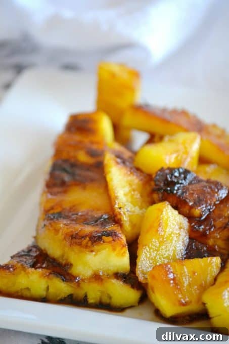 Close-up of grilled pineapple slices with a brown sugar glaze, ready to be served and enjoyed.