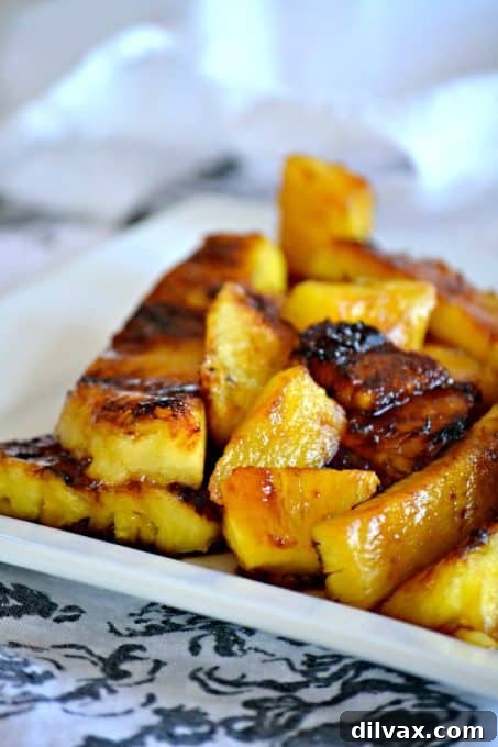 A collection of beautifully grilled pineapple slices, showcasing the caramelized texture.