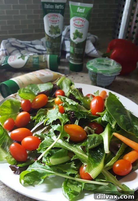 A vibrant salad featuring fresh ingredients, with Gourmet Garden herb pastes visible in the background, highlighting the sponsor's products.
