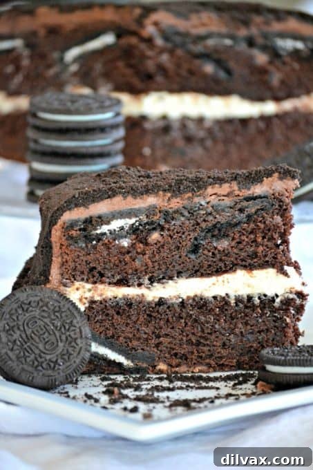 Decadent Oreo Dream Cake 14 This Oreo Cake is a surprise-inside cake with chocolate layers, an Oreo filling, covered in chocolate buttercream and topped with Oreo cookie crumbs.