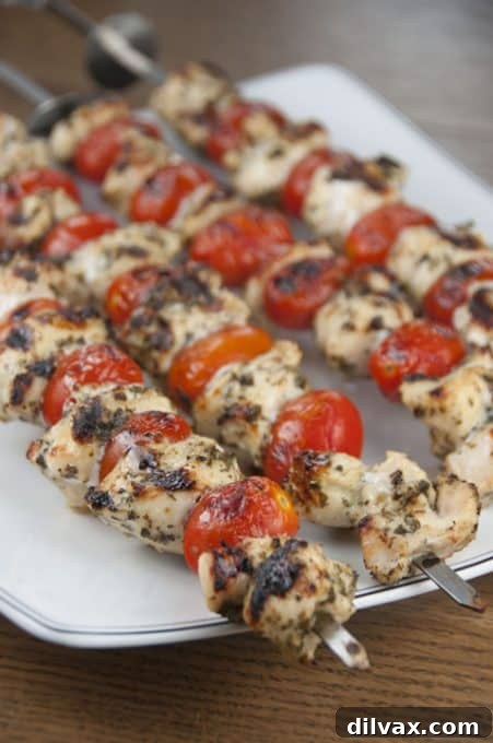 Grilled Pesto Chicken and Tomato Kabobs, featuring succulent chicken and cherry tomatoes.