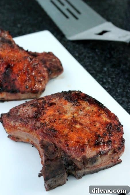 Thick, juicy Grilled Pork Chop with beautiful grill marks.