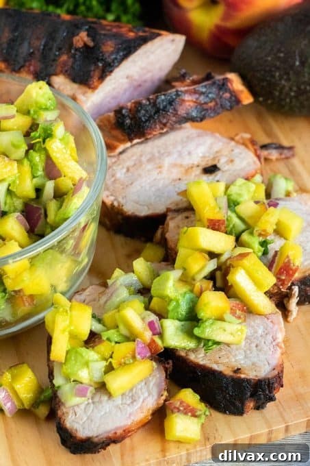 Grilled Pork Tenderloin served with a vibrant Avocado-Peach Salsa.