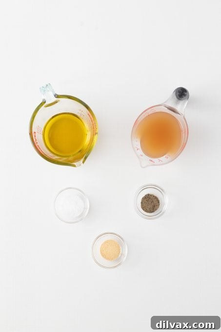 Vinaigrette ingredients for Three Bean Salad Dressing, including olive oil, apple cider vinegar, and spices.