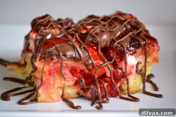 A glorious Chocolate Cherry Cheesecake Bread Pudding featuring golden-brown French bread cubes, vibrant cherry pie filling, creamy cheesecake pockets, and a generous drizzle of melted chocolate, ready to be enjoyed.