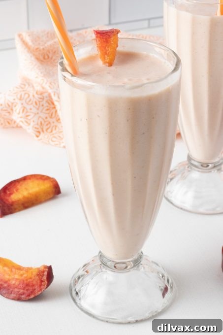 Frosted Peach Lemonade, a sweet and tangy frozen drink with peaches and lemonade.