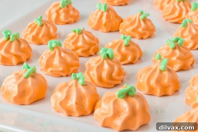 Homemade Pumpkin Spice Meringue Pumpkins arranged on a white serving plate