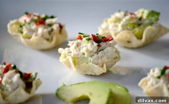 Avocado Tuna Delights 7 Colorful and flavorful, these Avocado Tuna Salad Bites are adorned with fresh chives and chili pepper flakes, making them a festive and delicious Game Day or party snack.