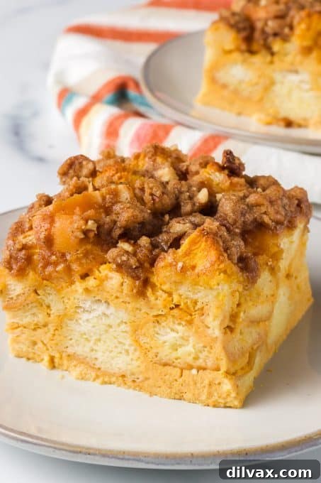 Spiced Pumpkin French Toast Bake 9 A close-up slice of Baked Pumpkin French Toast, showcasing its soft interior and crispy topping