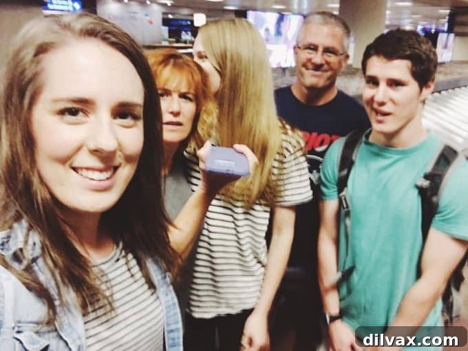 Family attempting a goofy selfie at the airport