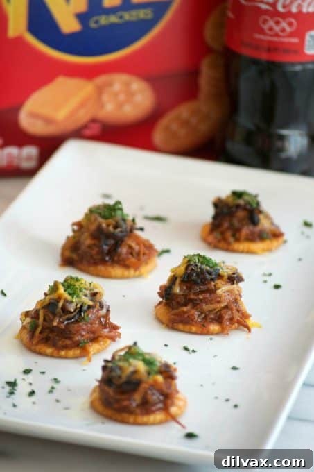 Sweet Heat Cola Pulled Pork Bites 10 A vibrant platter of Sweet and Spicy Coca-Cola Shredded Pork Bites, garnished with cilantro, ready to be served at a Game Day party.