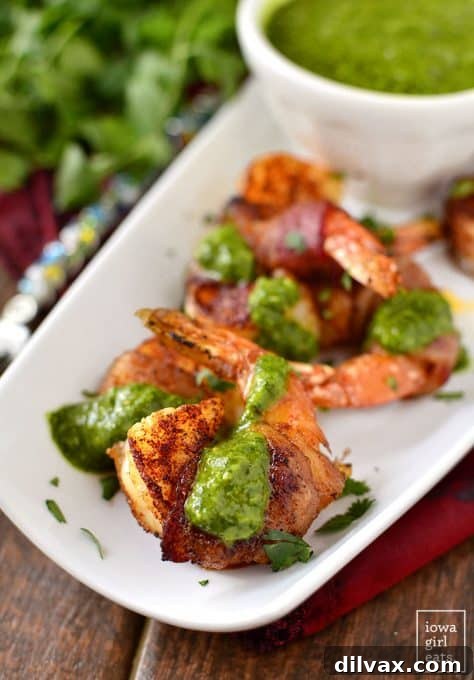 Touchdown Treats 34 Gourmet bacon-wrapped BBQ shrimp with a vibrant chimichurri dipping sauce, an impressive appetizer.