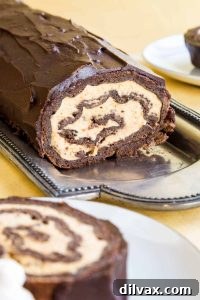An elegant Gluten Free Pumpkin Cheesecake Chocolate Roll, perfectly sliced and displaying its beautiful layers.