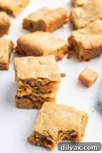 Golden Caramel Pecan Blondies, rich with pecans and a sticky caramel swirl, presented on a rustic surface.