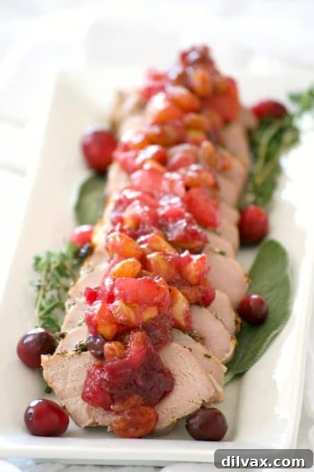 This Dijon Herb Roasted Pork with Cranberry Pear Chutney made with a Smithfield Prime Pork Tenderloin is an easy and delicious dinner perfectly suited for holiday entertaining!